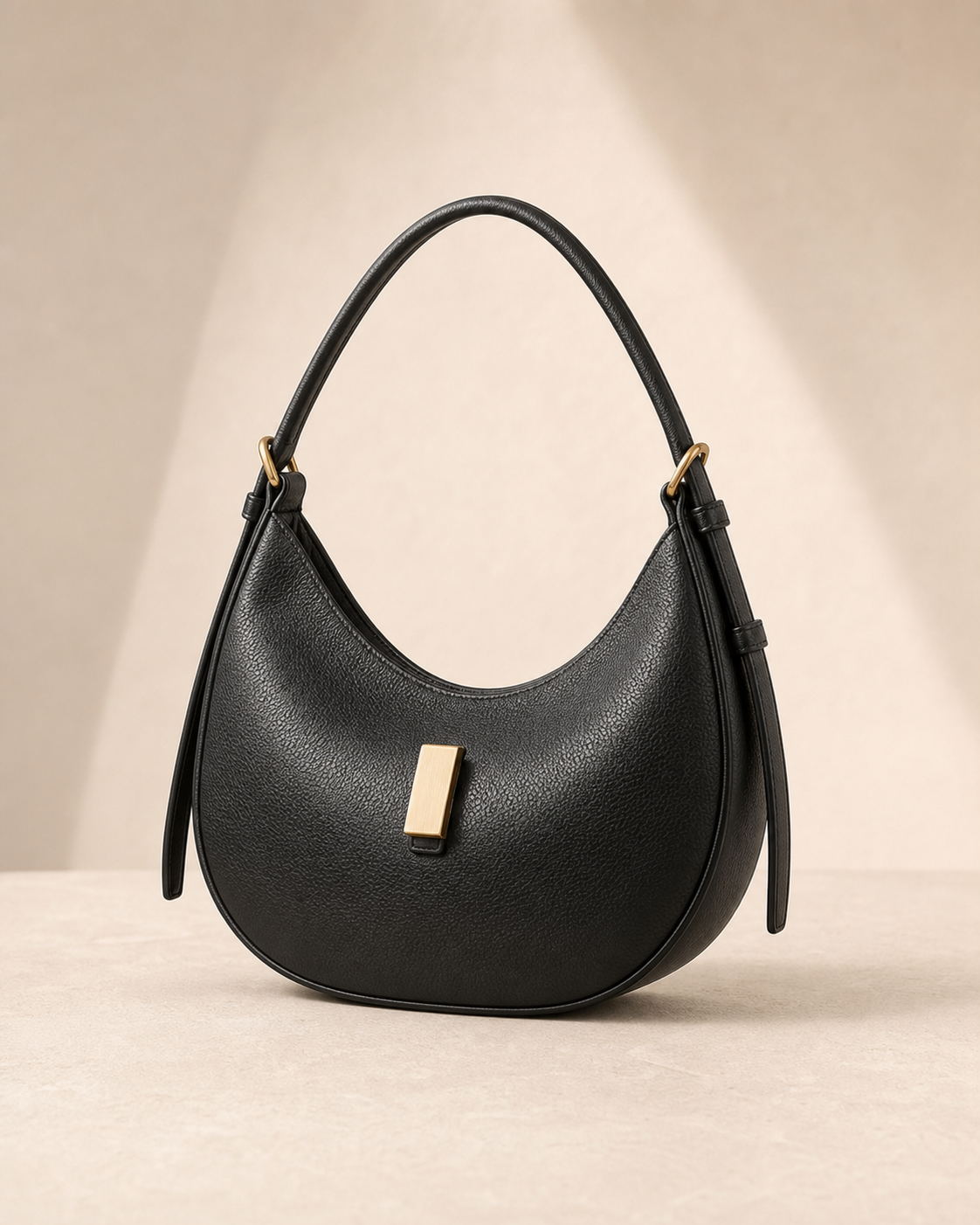 Black leather shoulder bag in a refined studio